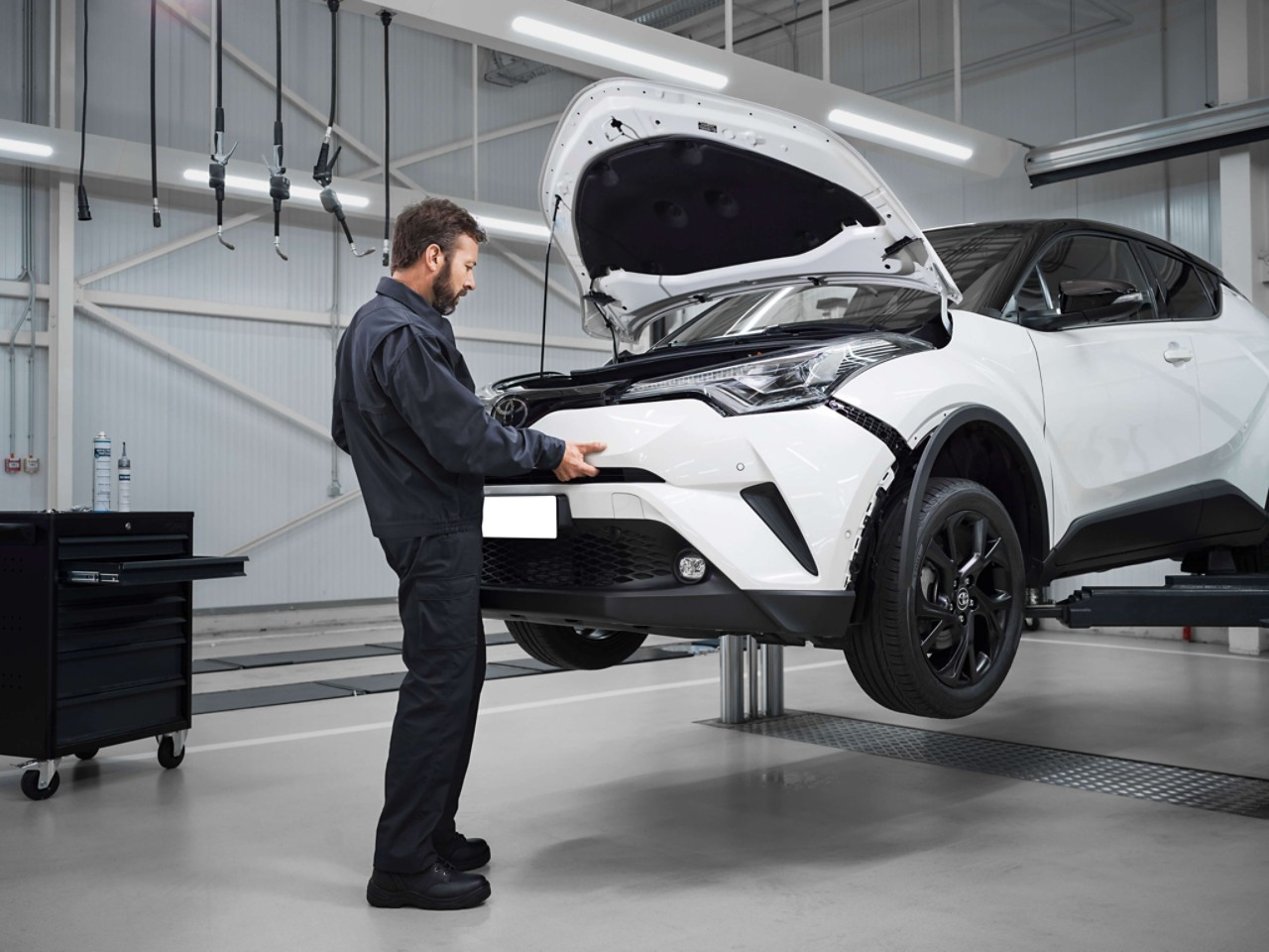 Man and woman inspecting car